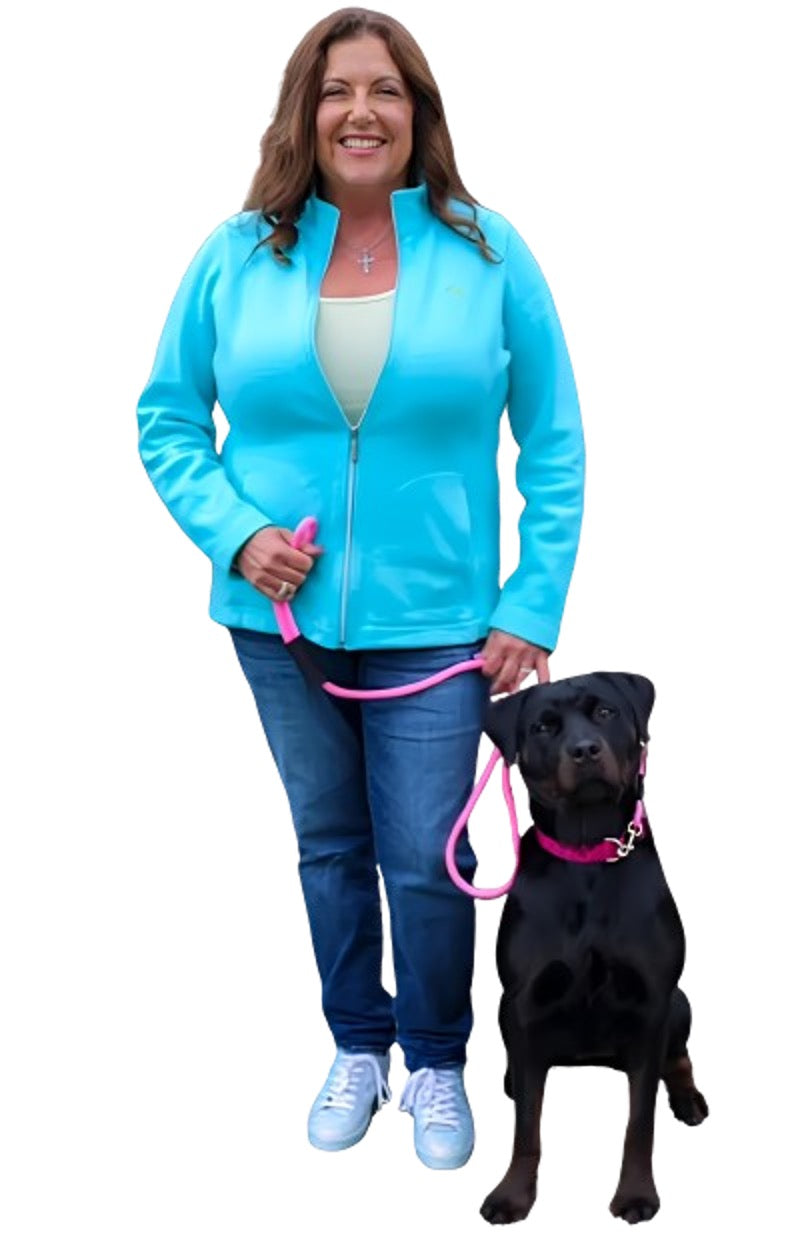 Happy woman with black dog on leash